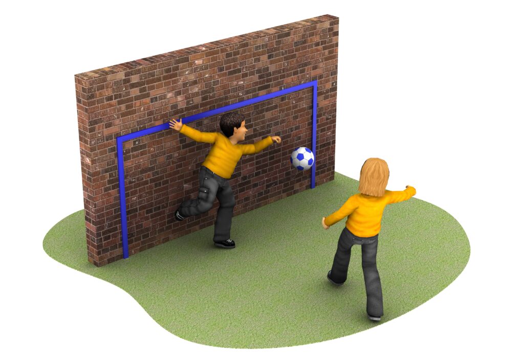 Two children play football on grass; one kicks a ball towards a goal painted on a brick wall as the other stands defending.