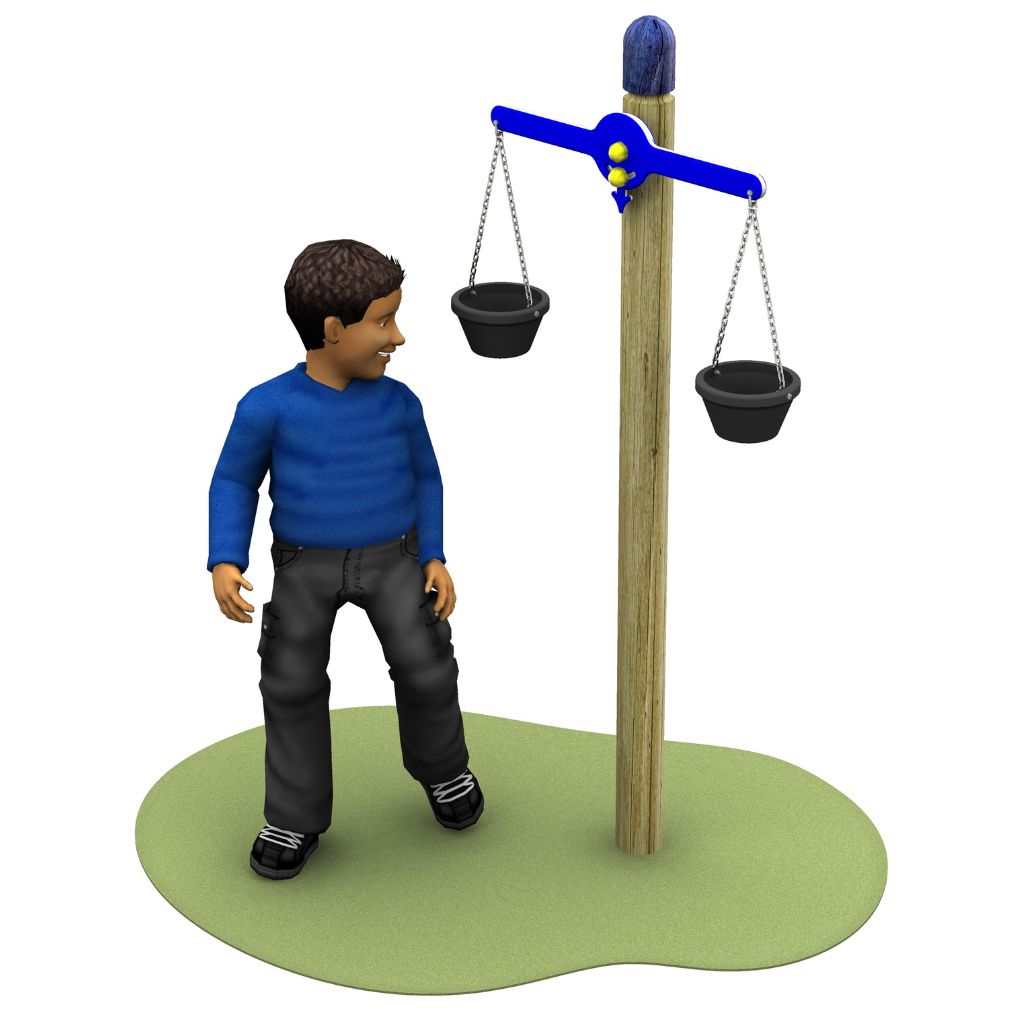 A boy in a blue jumper stands on green ground beside a balance scale with two black buckets hanging from each side.