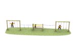 Three children play on a playground assault course featuring rope swings, balance beams, and climbing ropes on a grassy area.