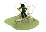 A child in a green shirt and black trousers balances on the Link Mini Balance Beam, a wooden structure set in a playground area with grass underneath.