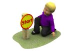 A child kneels on grass next to a wooden post with a yellow and red Sports Challenge Start Sign.