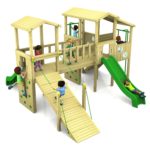 Children playing on a wooden playground structure featuring slides, climbing walls, rope bridge, and raised platforms.