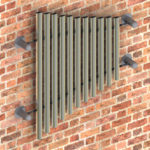 A metal pipe on a brick wall.