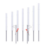 Seven vertical white metal poles with varying heights are mounted on grey bases; two poles have attached red and black cables.