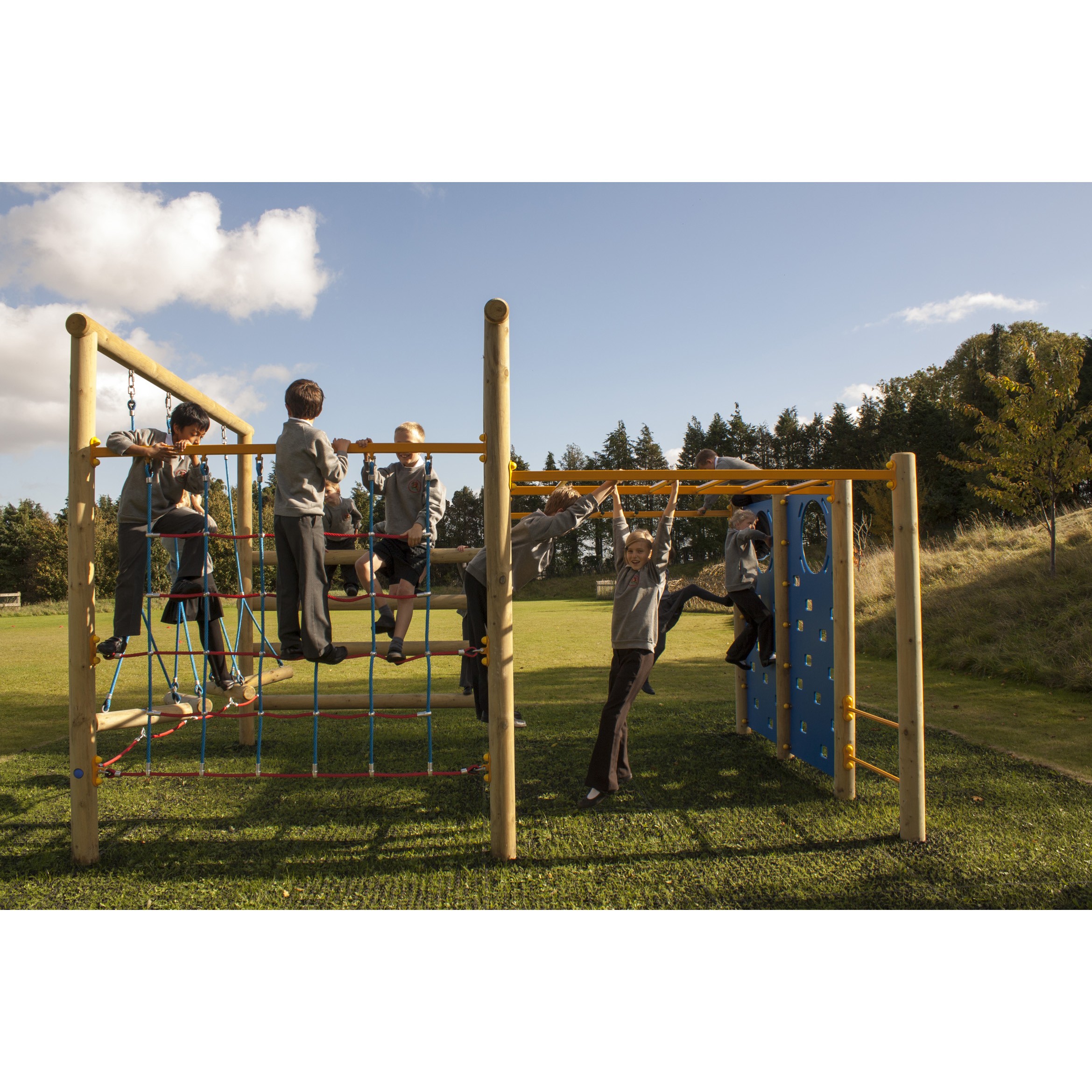 Children in school uniforms play on an Orbiter Space Frame climbing structure with ropes and bars in an outdoor playground on a sunny day.