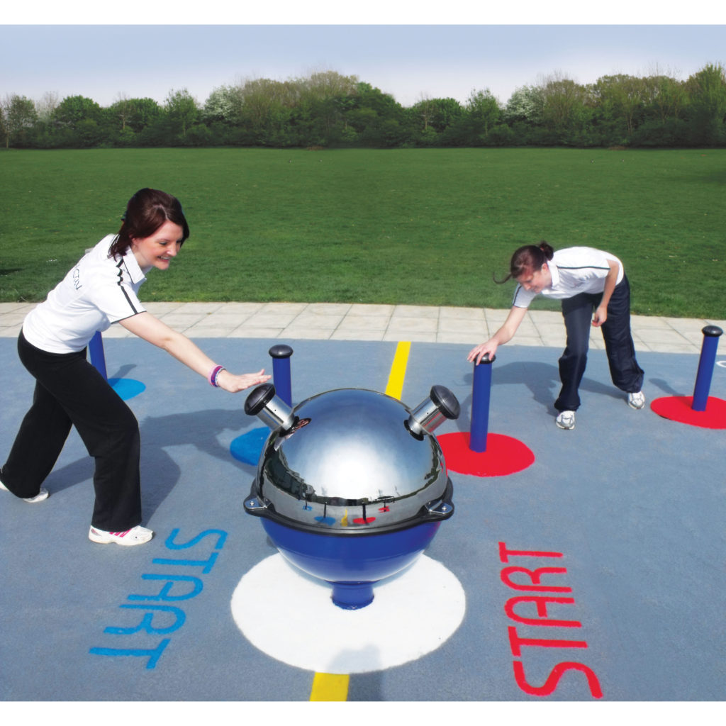 Two people in sportswear face each other on a games court, each touching a post near a spherical, metallic object at the centre, with START marked on the ground.