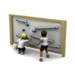 Two children play with a vertical marble run wall, adjusting tubes and ramps just like on a Mark Making Water Wall, guiding marbles from top to bottom.