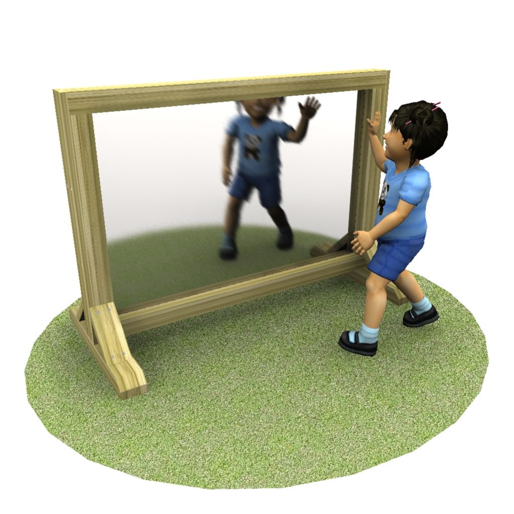 A child in blue clothing stands on grass and touches a large, freestanding rectangular mirror, with their reflection visible.