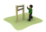 A child in a green jumper stands on grass, reaching towards a vertical outdoor musical instrument with metal bars mounted between two wooden posts.