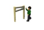A child in a green jumper raises a hand towards an outdoor musical instrument with metal bars mounted on two wooden posts.