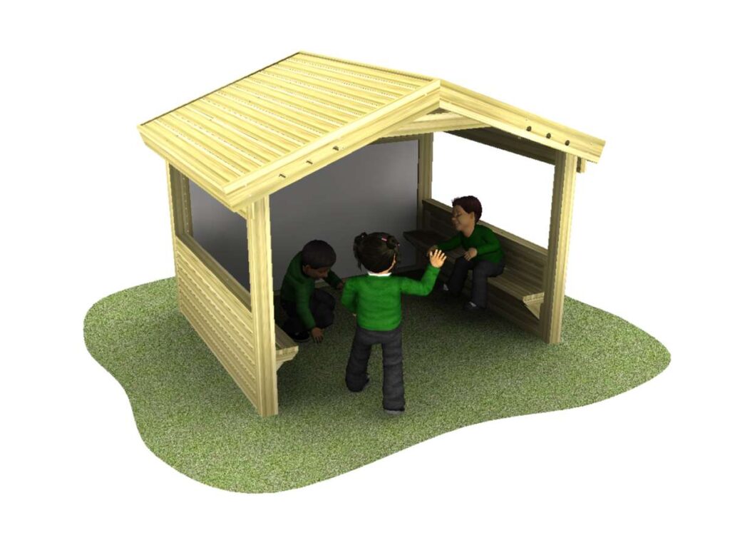 Three children in green jumpers are interacting inside and outside a small wooden shelter with benches, situated on a patch of grass.