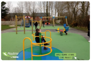 Children play on various playground equipment, including a roundabout, see-saw, and swings, whilst adults stand nearby. The area, designed by James Rennie, is surrounded by trees and a fence.