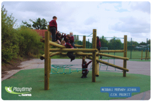 Nerrols Primary School outdoor play equipment, timber pick up sticks from Playtime by Fawns. Children in maroon jumpers climbing on the equipment