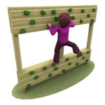 A child wearing a purple outfit climbs a wooden climbing wall with green holds, set on a patch of grass.