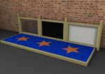 A wooden-framed sensory wall with three panels—clear, black, and white—stands behind a blue platform featuring three orange stars, set against a brick wall backdrop.
