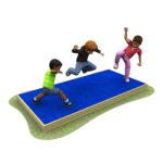 Three children are jumping and playing on a rectangular blue mat placed on the ground.